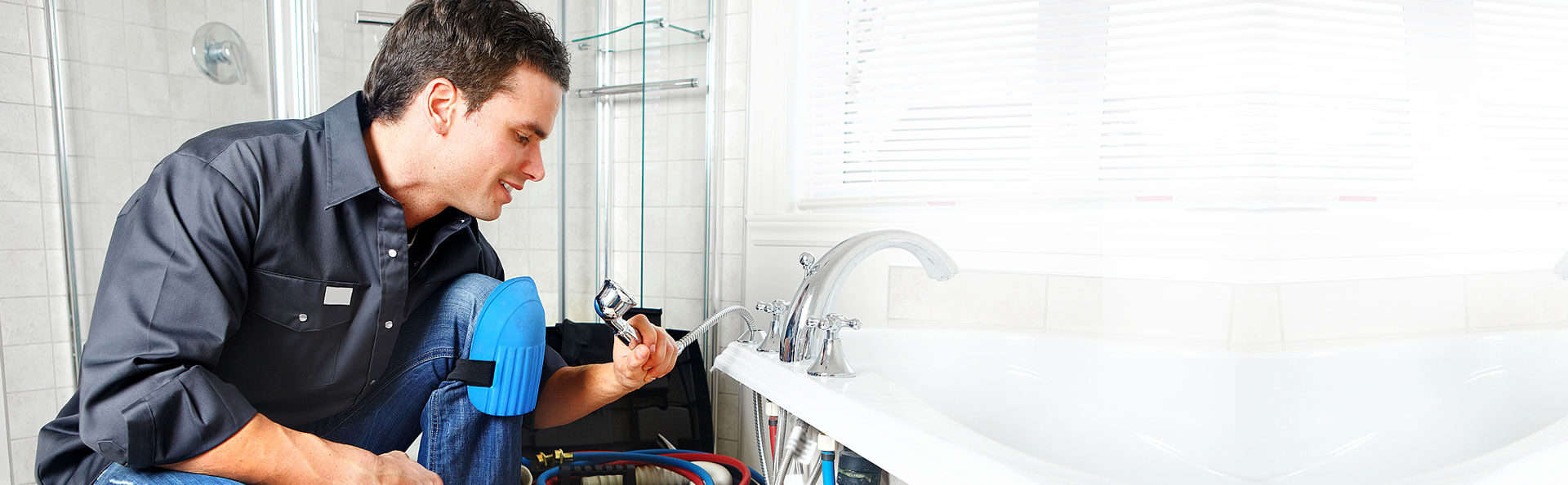 plumber holding a shower in his hand