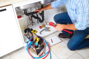Plumber fixing sink pipes